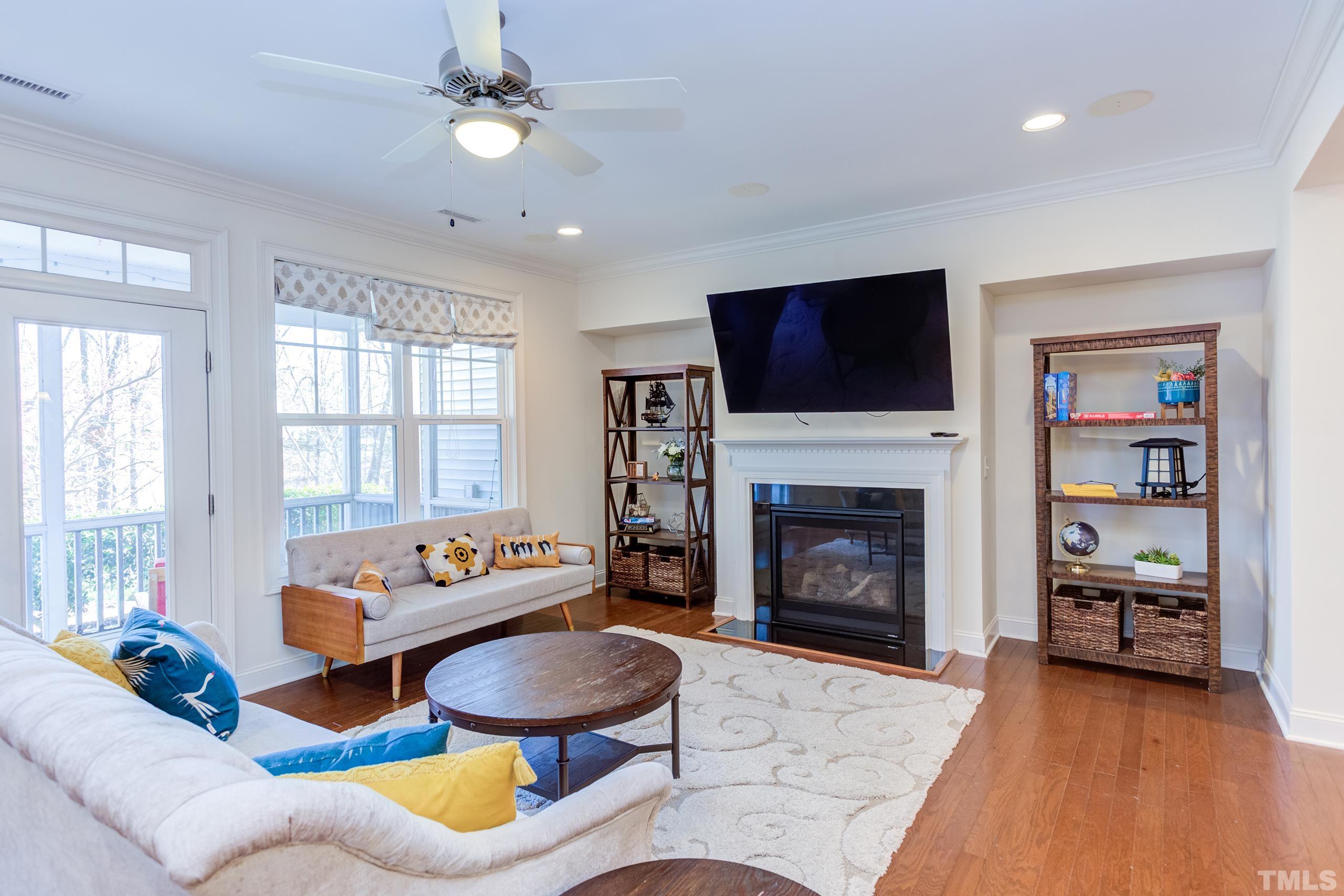 449 Talons Rest Way Cary, NC 27513 - Photo 17 of 54 a living room with furniture a fireplace and a flat screen tv