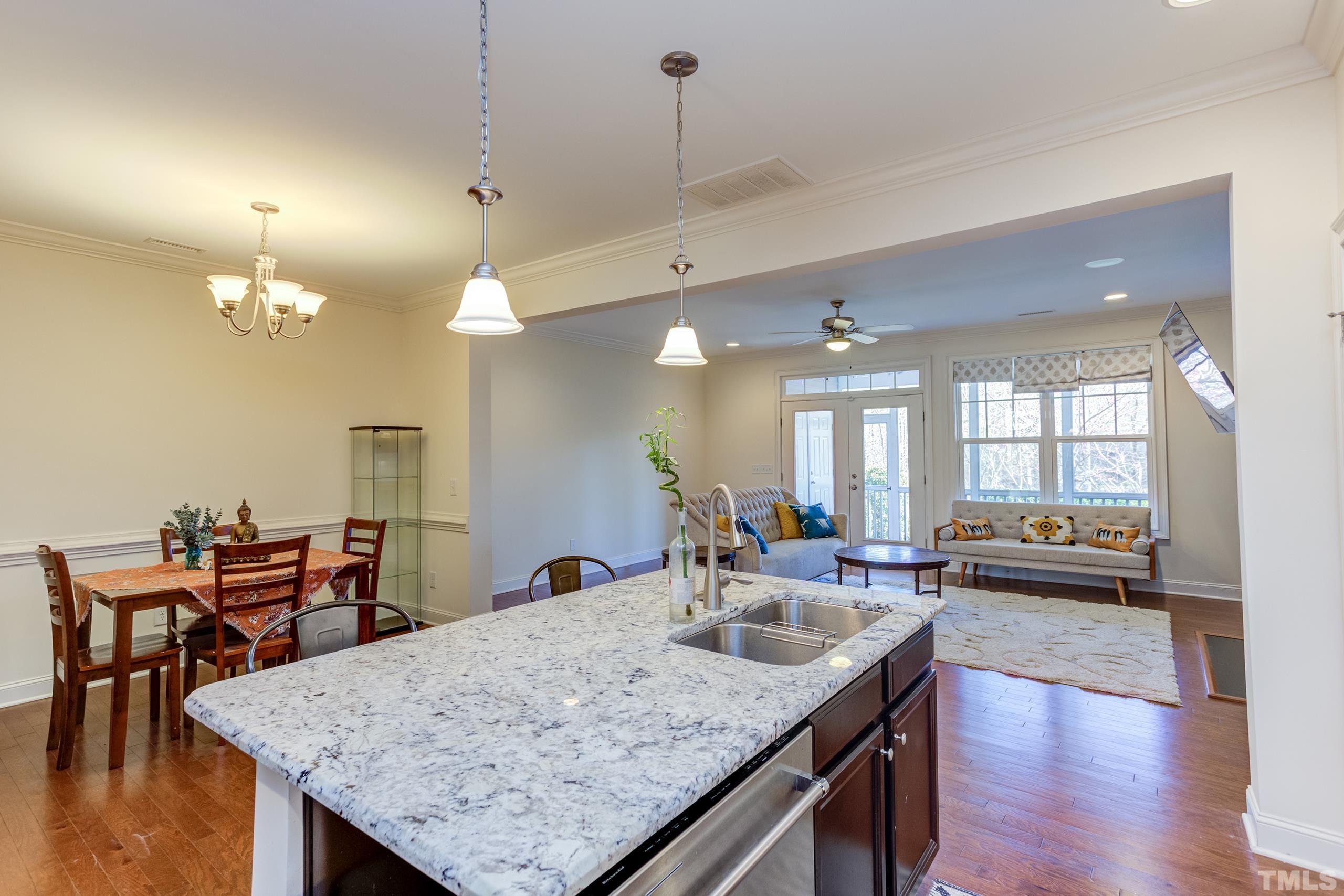 449 Talons Rest Way Cary, NC 27513 - Photo 18 of 54 a kitchen with center island table and chairs