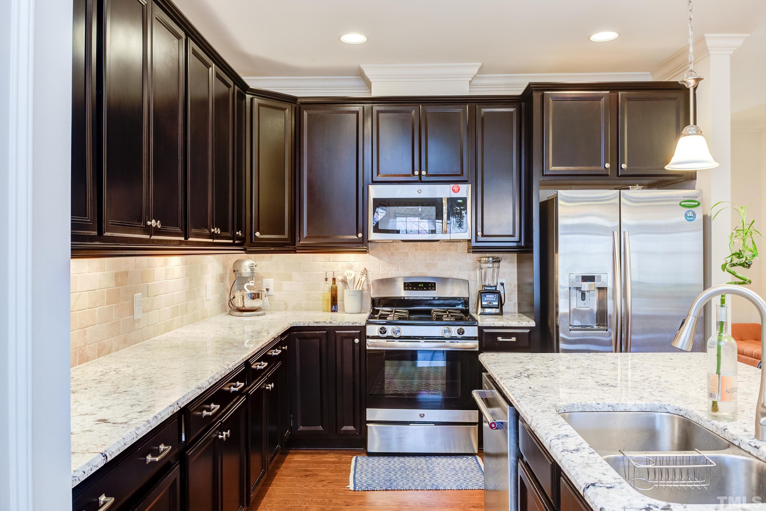 449 Talons Rest Way Cary, NC 27513 - Photo 2 of 54 a kitchen with stainless steel appliances granite countertop a sink stove and refrigerator