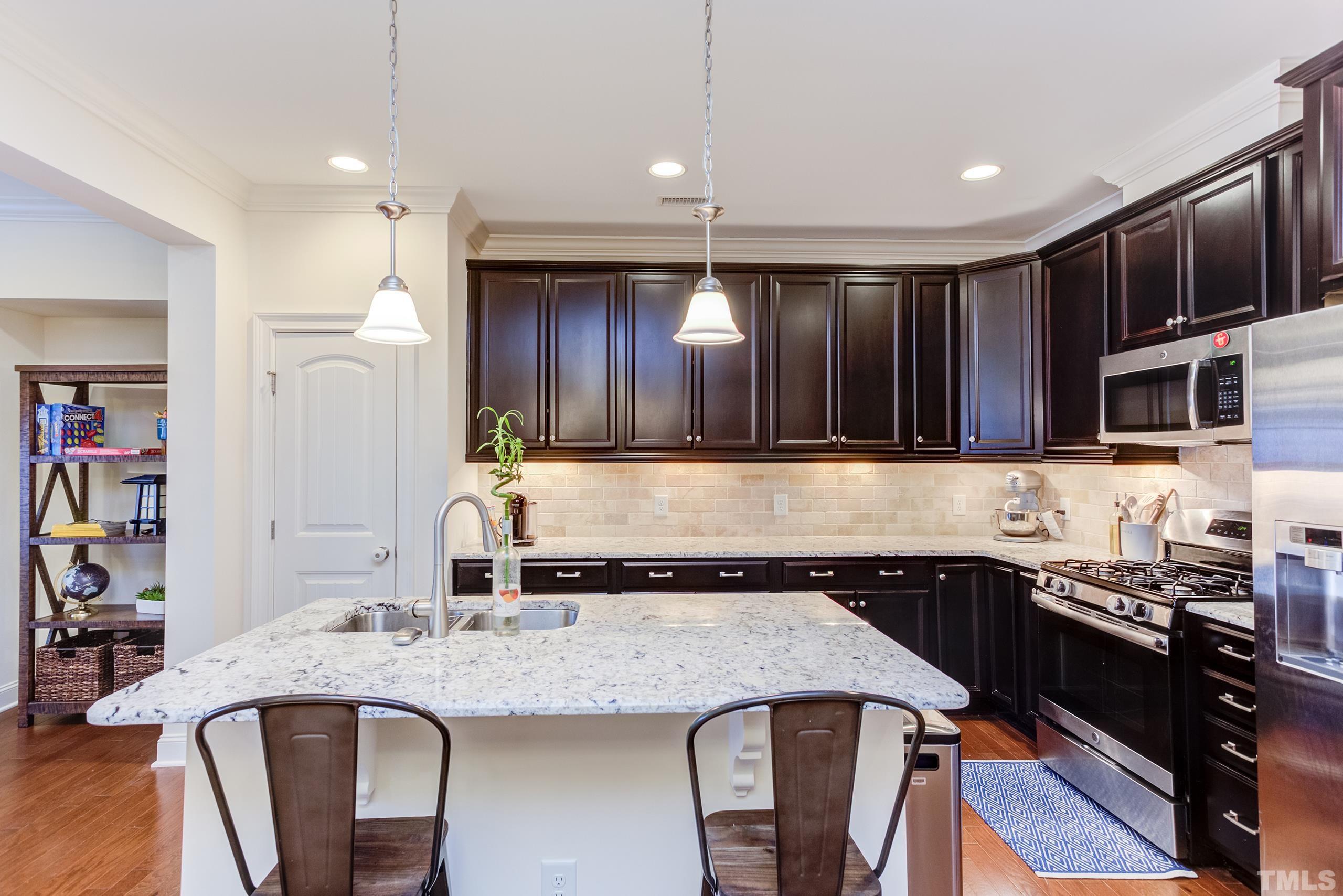 449 Talons Rest Way Cary, NC 27513 - Photo 24 of 54 a kitchen with granite countertop stainless steel appliances and wooden cabinets