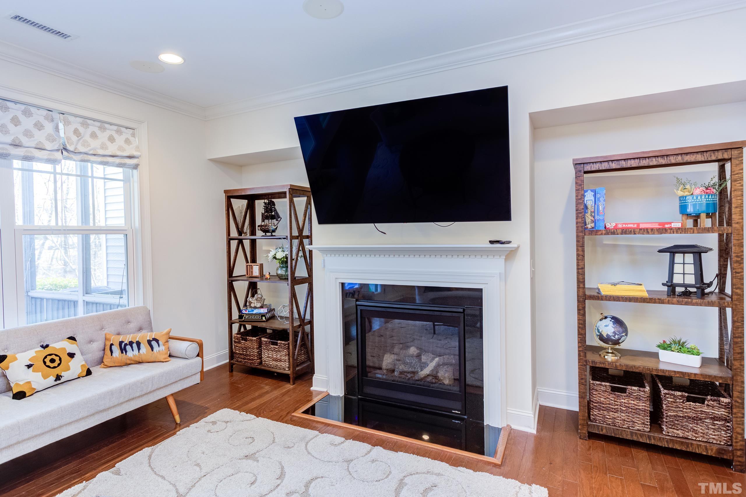 449 Talons Rest Way Cary, NC 27513 - Photo 25 of 54 a living room with furniture a flat screen tv and a fireplace