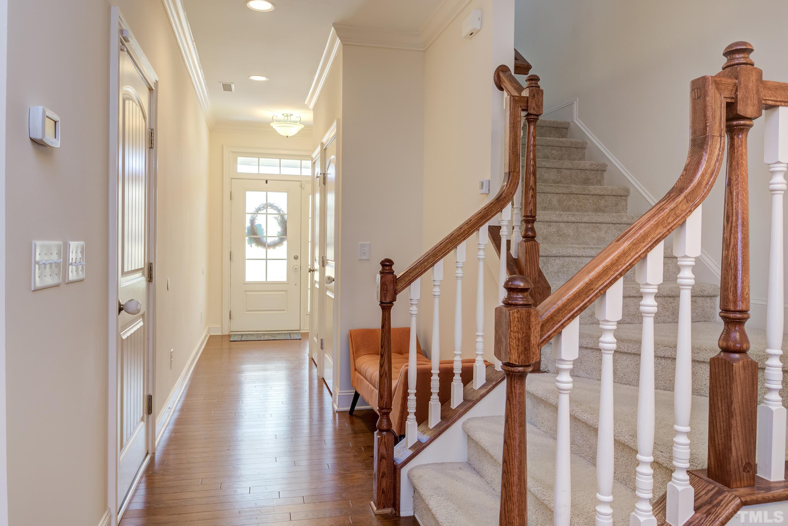 449 Talons Rest Way Cary, NC 27513 - Photo 26 of 54 a view of an entryway with wooden floor and stairs