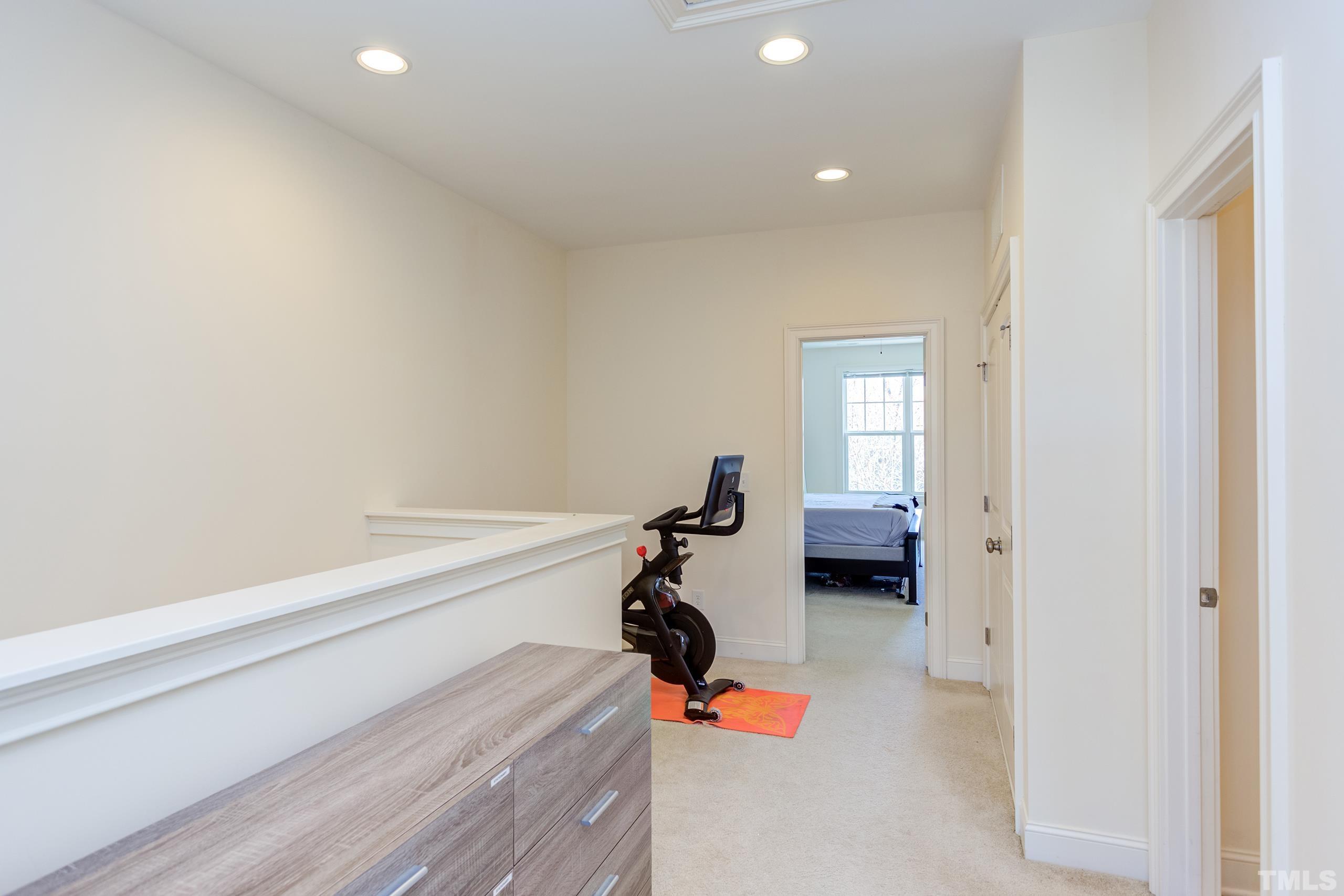 449 Talons Rest Way Cary, NC 27513 - Photo 28 of 54 a bedroom with a bed and a chandelier