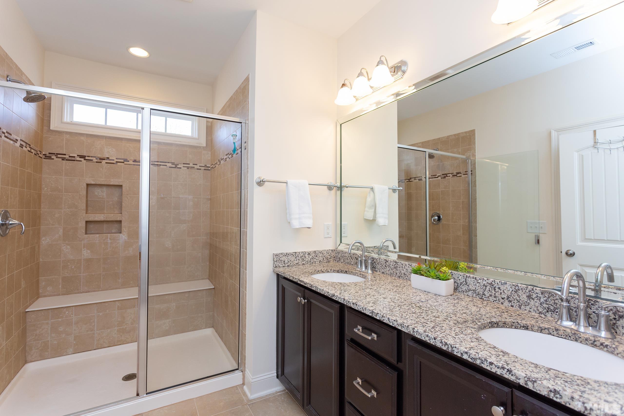 449 Talons Rest Way Cary, NC 27513 - Photo 30 of 54 a bathroom with a granite countertop shower sink and mirror