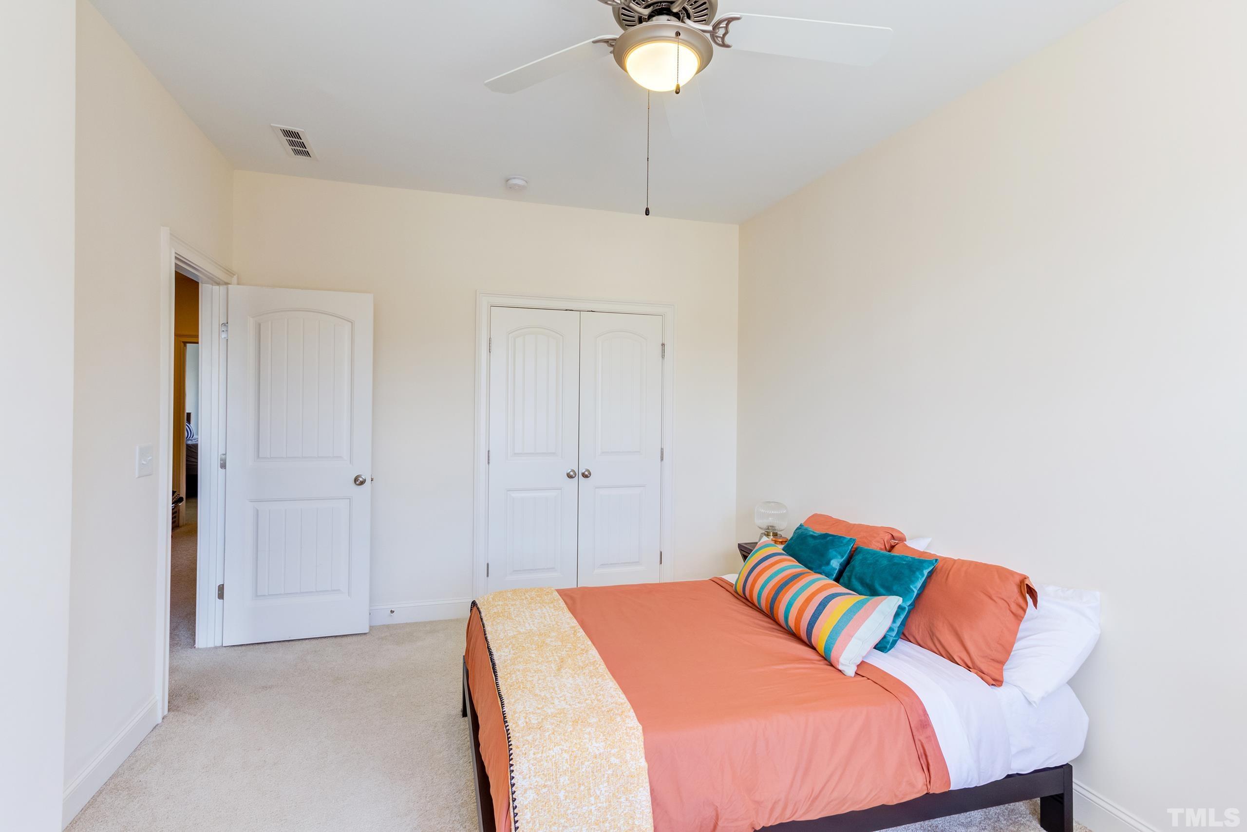 449 Talons Rest Way Cary, NC 27513 - Photo 34 of 54 a bedroom with a bed and chandelier