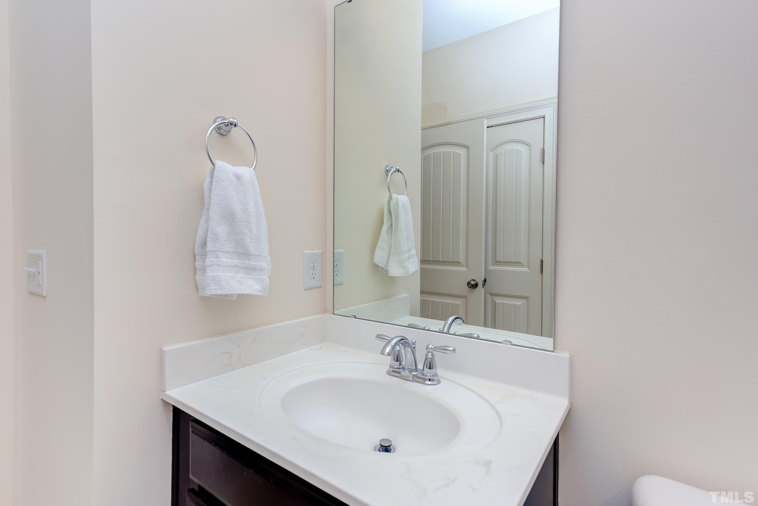 449 Talons Rest Way Cary, NC 27513 - Photo 40 of 54 a bathroom with a sink and a mirror