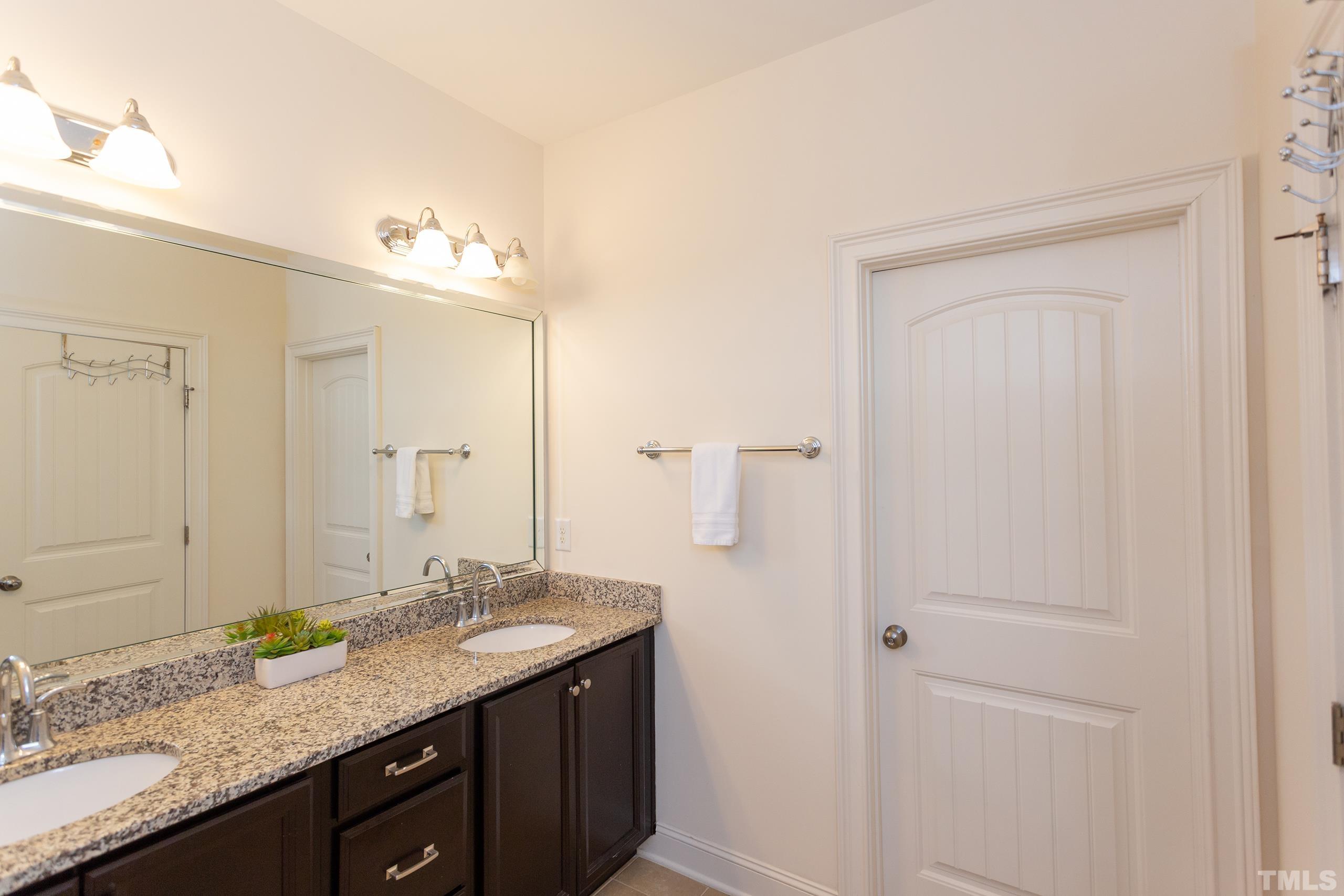 449 Talons Rest Way Cary, NC 27513 - Photo 44 of 54 a bathroom with a granite countertop sink and a mirror