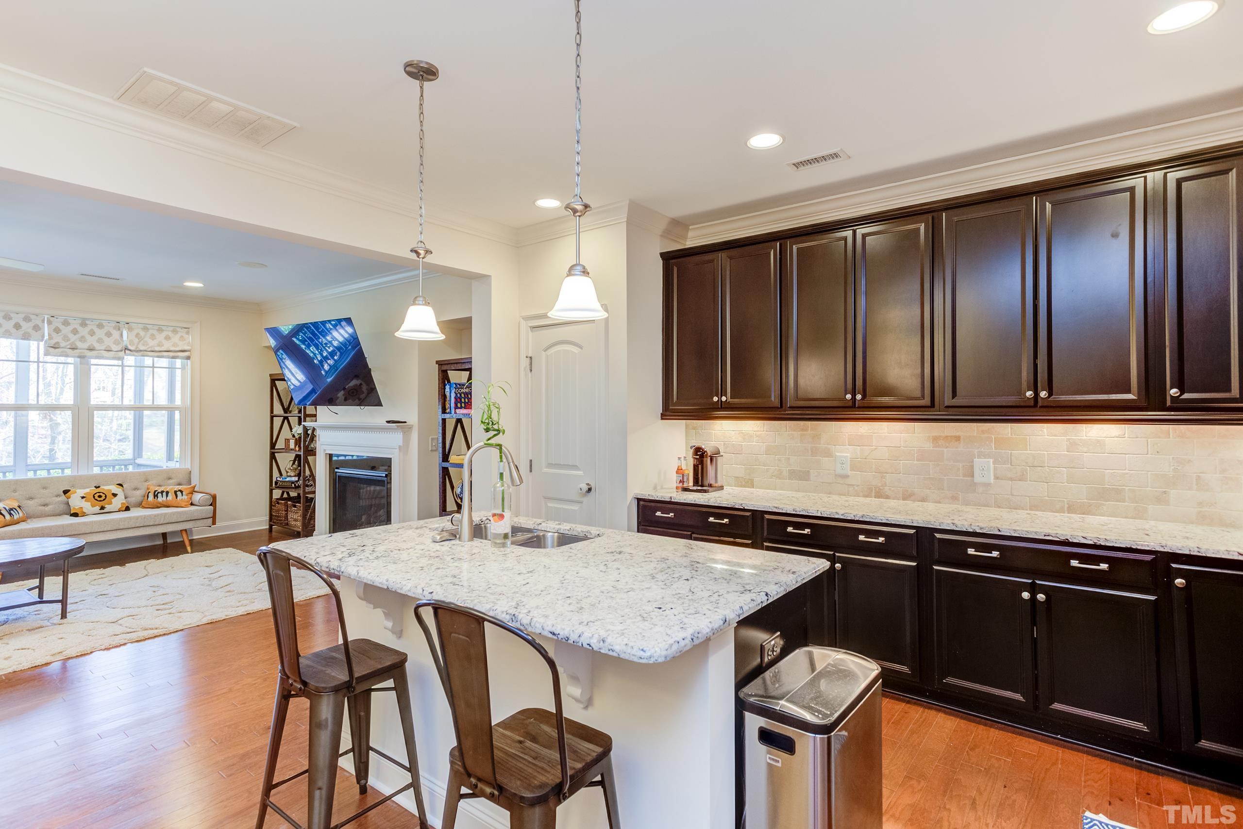 449 Talons Rest Way Cary, NC 27513 - Photo 7 of 54 a kitchen with granite countertop a stove a sink and a refrigerator