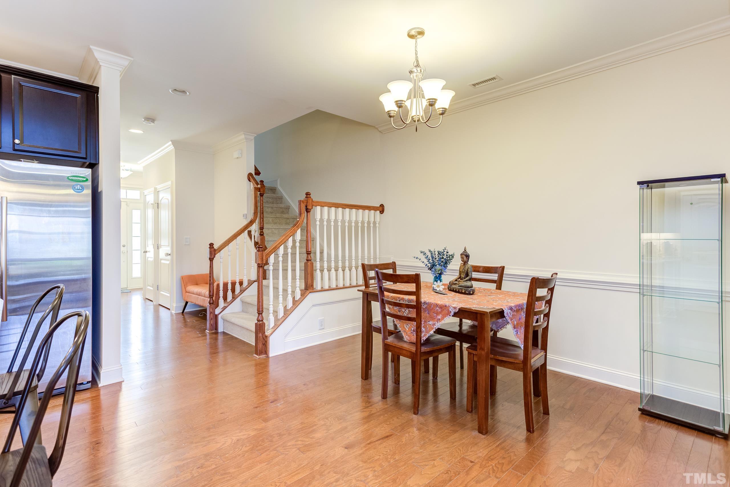 449 Talons Rest Way Cary, NC 27513 - Photo 9 of 54 a view of a dining room with furniture wooden floor and chandelier