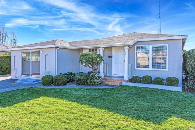a front view of a house with garden