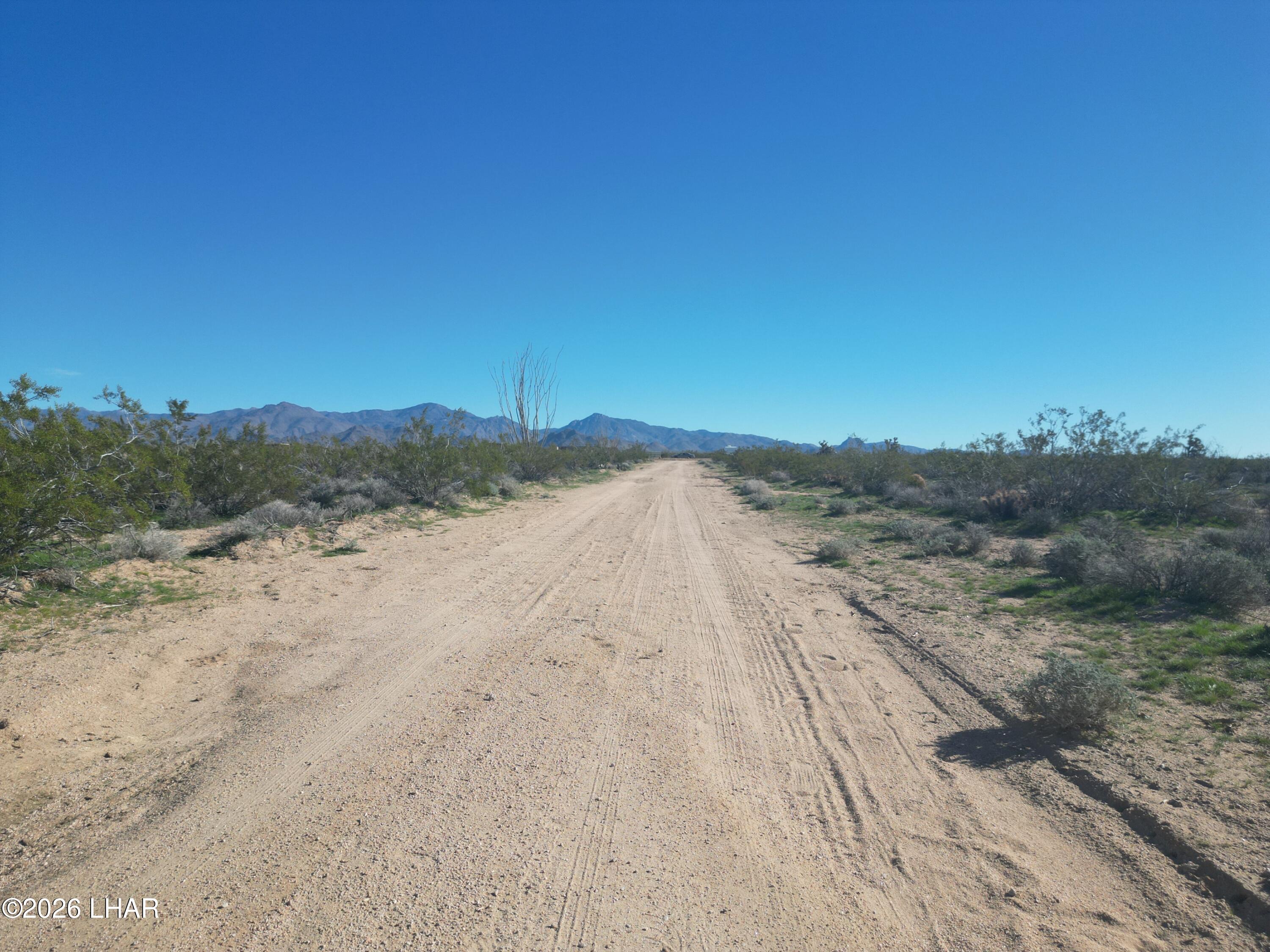 18206 South Gene Autry Road Yucca, AZ 86438 - Photo 9 of 17 a view of dirt field and mountains