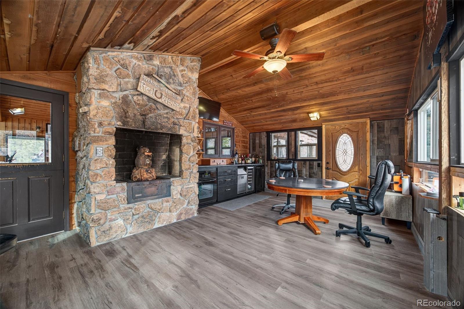 450 East Happy Canyon Road Castle Rock, CO 80108 - Photo 36 of 48 a work room with furniture and a fireplace