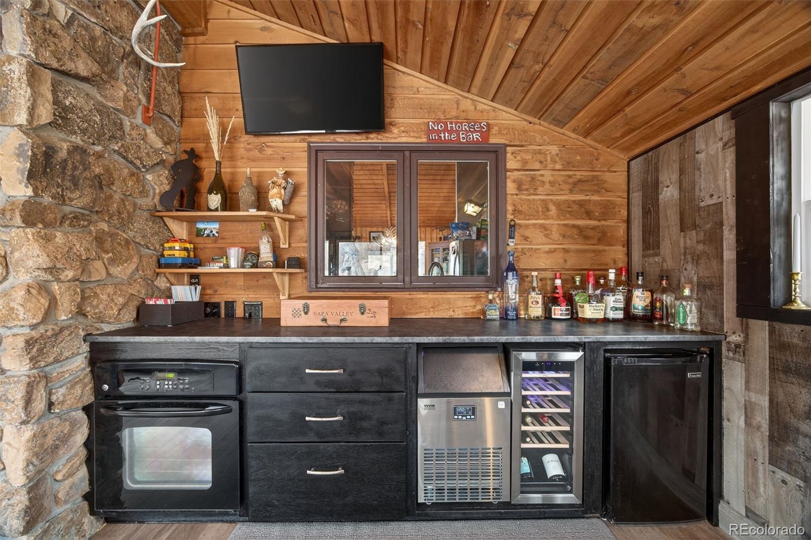 450 East Happy Canyon Road Castle Rock, CO 80108 - Photo 38 of 48 a kitchen with a sink a stove and wooden cabinets