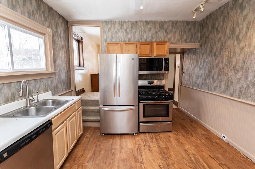 1206 Sycamore Street Connellsville, PA 15425 - Photo 14 of 35 a kitchen with a refrigerator and a sink