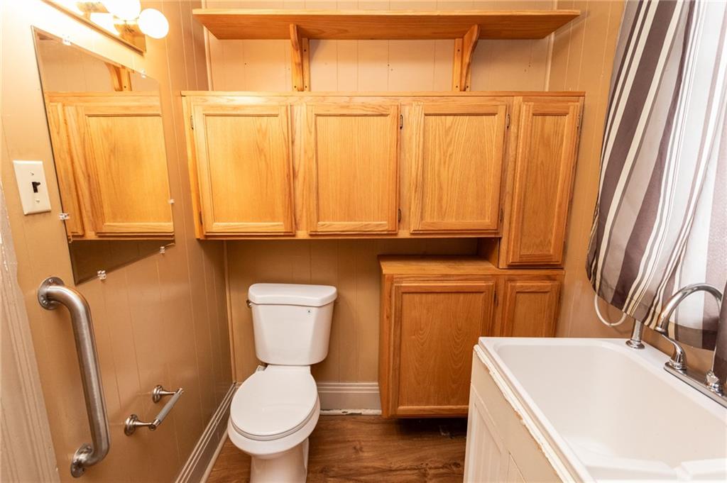 1206 Sycamore Street Connellsville, PA 15425 - Photo 19 of 35 a white toilet sitting next to a bathroom sink