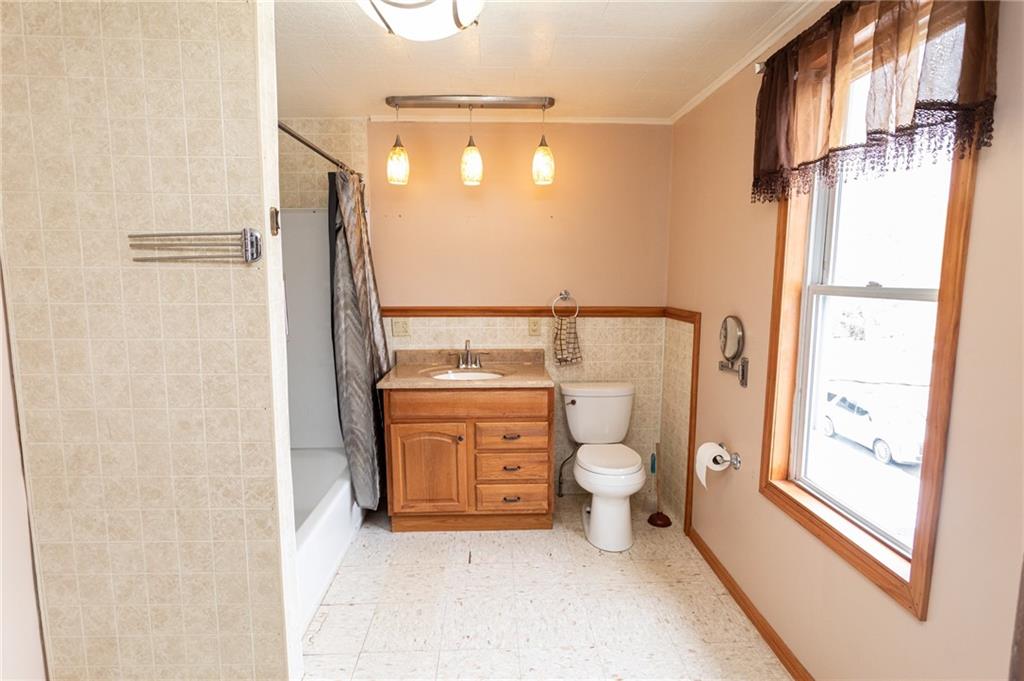 1206 Sycamore Street Connellsville, PA 15425 - Photo 30 of 35 a bathroom with a granite countertop toilet and a shower