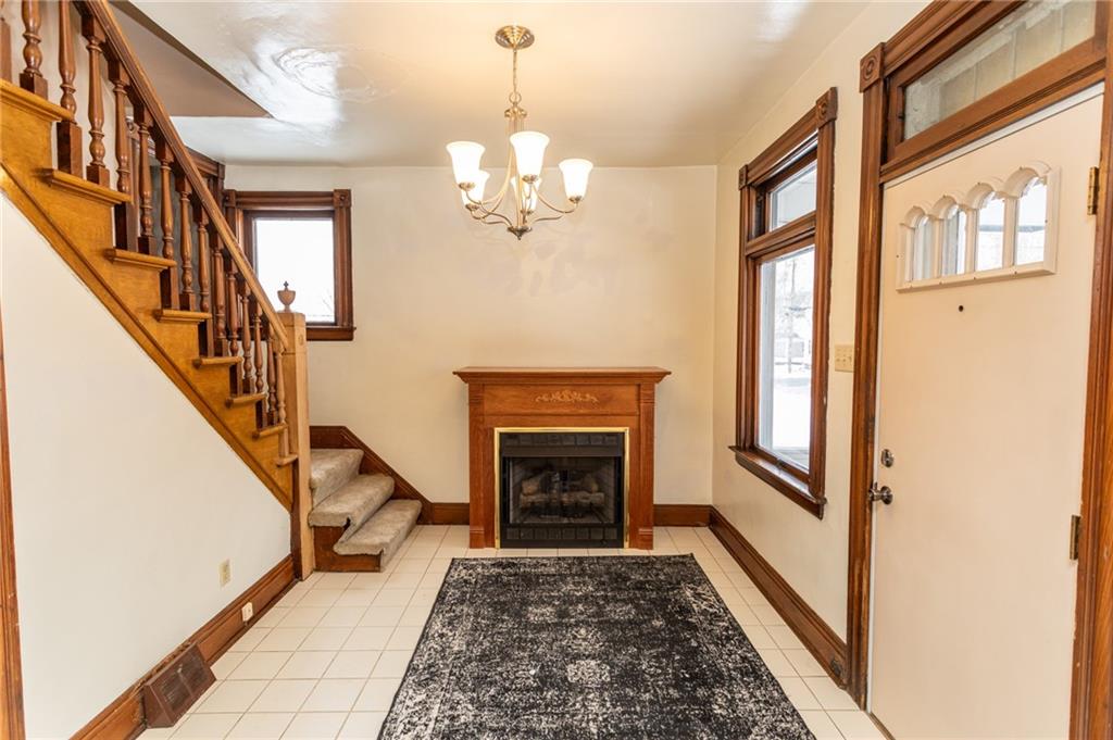 1206 Sycamore Street Connellsville, PA 15425 - Photo 7 of 35 a view of a livingroom with wooden floor and a fireplace