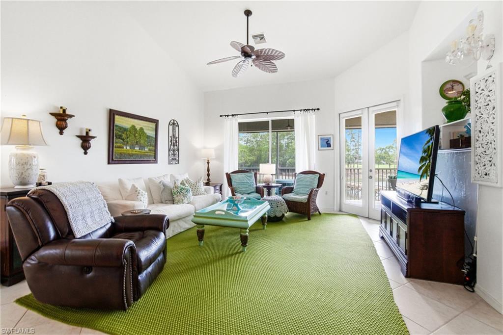 8430 Radcliffe Terrace, Unit 202 Naples, FL 34120 - Photo 10 of 37 a living room with furniture and a large window