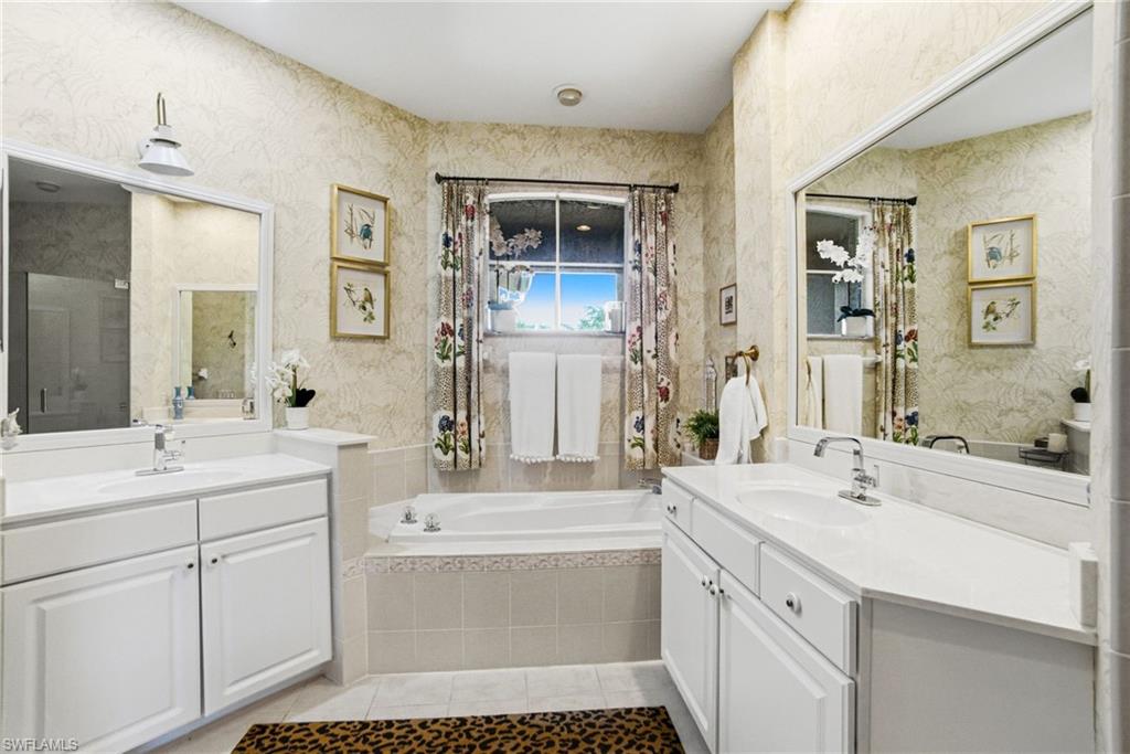 8430 Radcliffe Terrace, Unit 202 Naples, FL 34120 - Photo 19 of 37 a bathroom with a sink a toilet and mirror