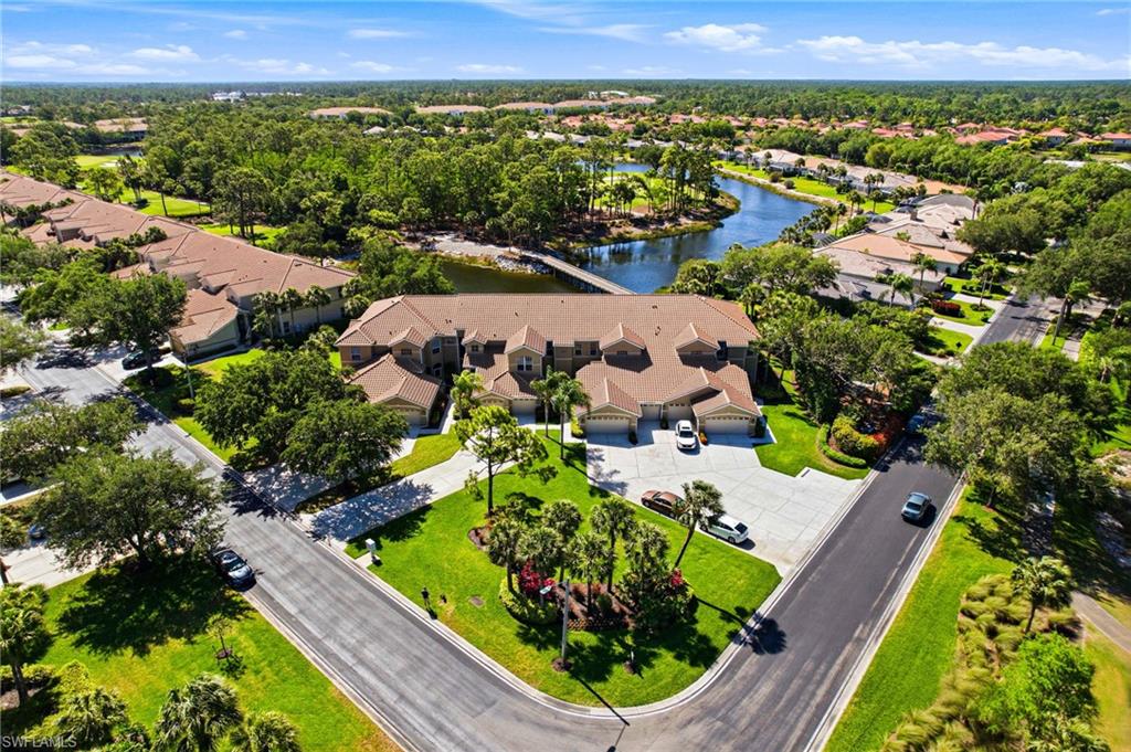 8430 Radcliffe Terrace, Unit 202 Naples, FL 34120 - Photo 2 of 37 an aerial view of a residential houses with a yard and lake view
