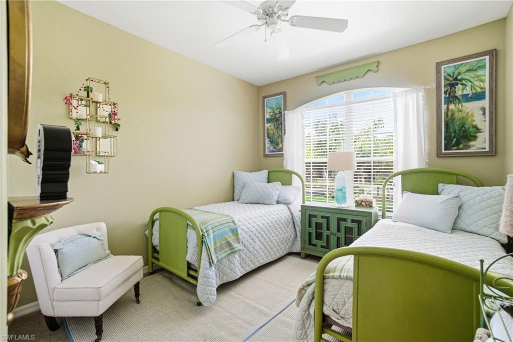 8430 Radcliffe Terrace, Unit 202 Naples, FL 34120 - Photo 21 of 37 a bedroom with two beds and a couch