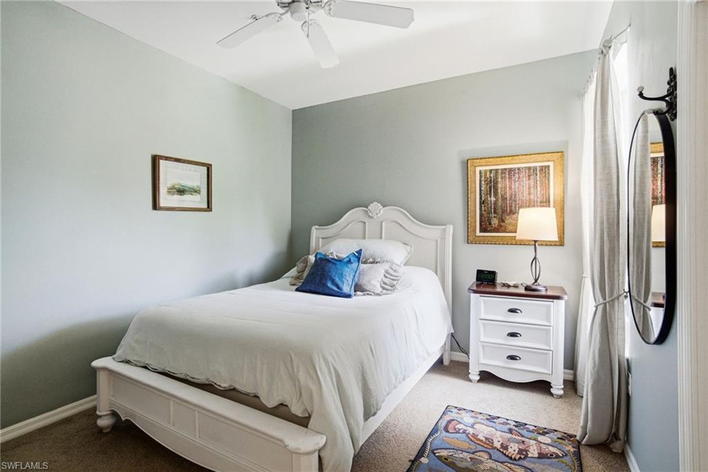 8430 Radcliffe Terrace, Unit 202 Naples, FL 34120 - Photo 23 of 37 a bedroom with a bed and a tv