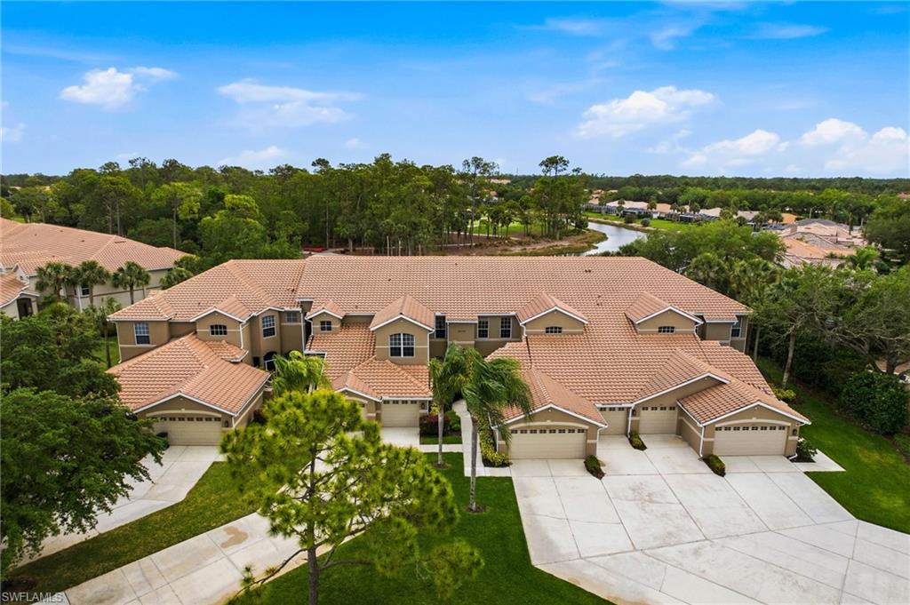 8430 Radcliffe Terrace, Unit 202 Naples, FL 34120 - Photo 36 of 37 an aerial view of a house with a garden and lake view