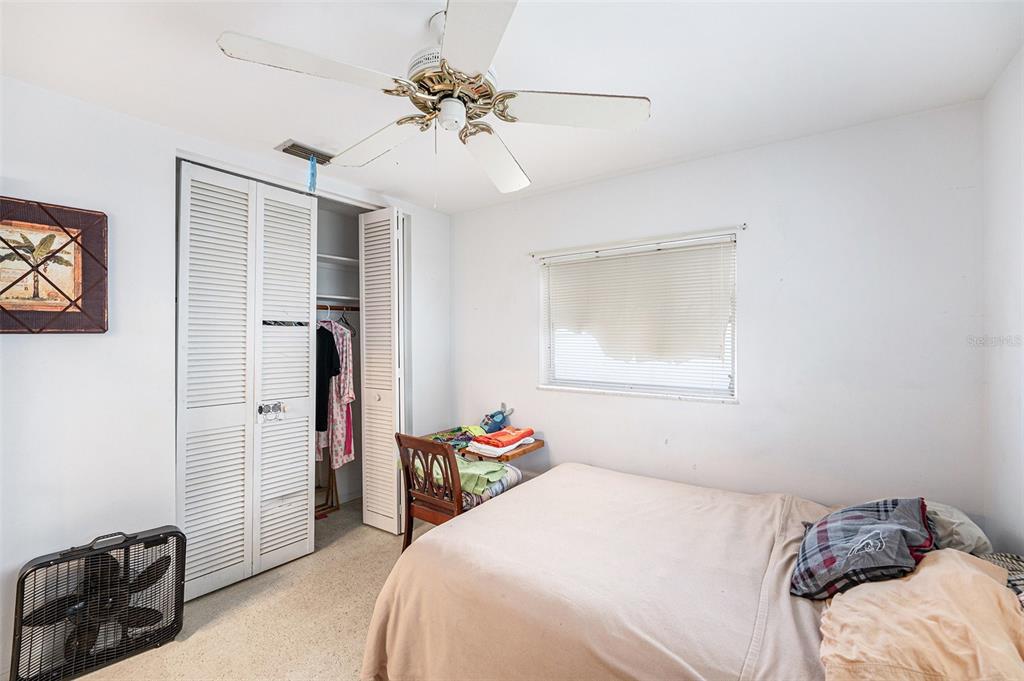 2066 High Ridge Drive Clearwater, FL 33763 - Photo 8 of 15 a bedroom with a bed and a chandelier