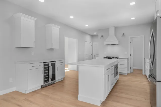 a kitchen with stove top oven and refrigerator