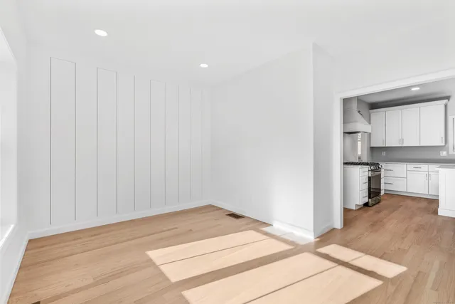 a view of a kitchen with a sink and a refrigerator