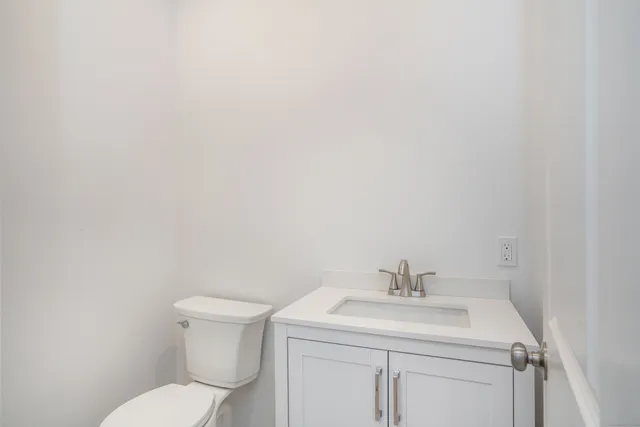 a bathroom with a sink a toilet and a mirror