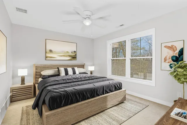 a bedroom with a bed and a large window