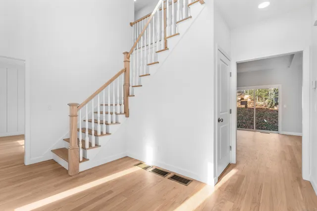 a view of entryway and hall with wooden floor