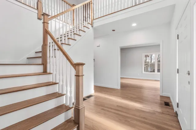 a view of entryway and hall with wooden floor