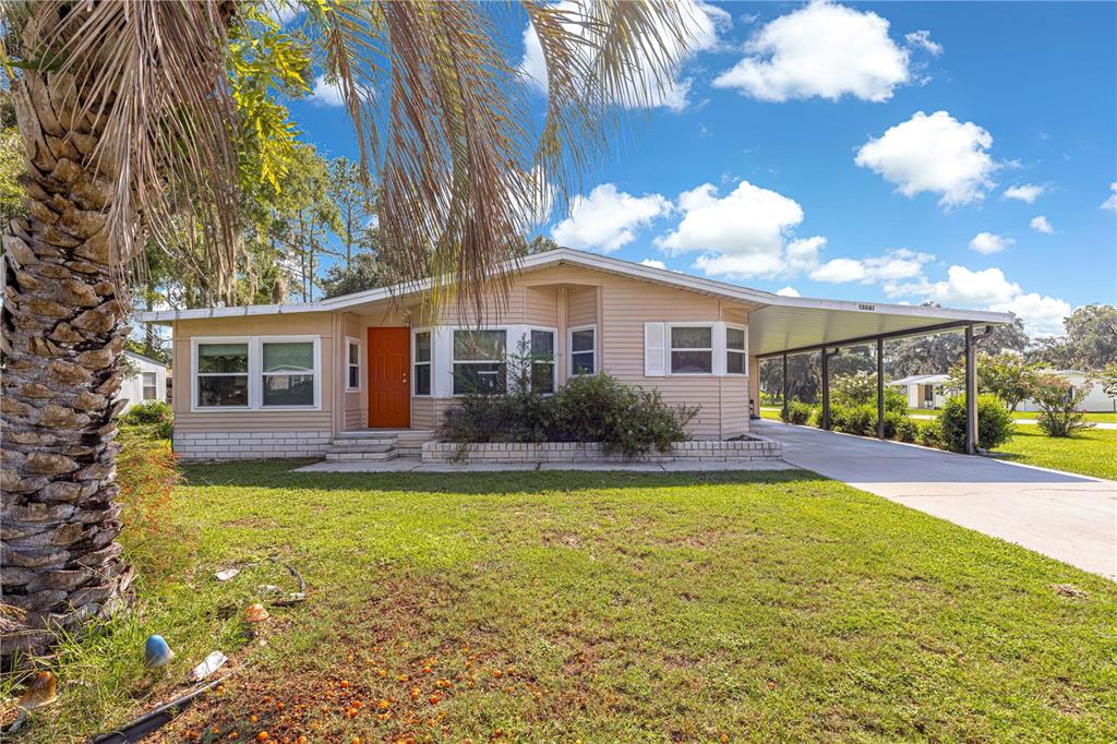 a view of a house with swimming pool and a yard