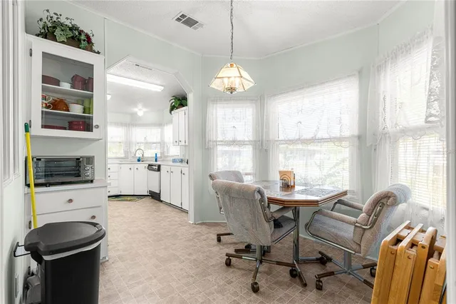 a view of a livingroom with workspace and a window