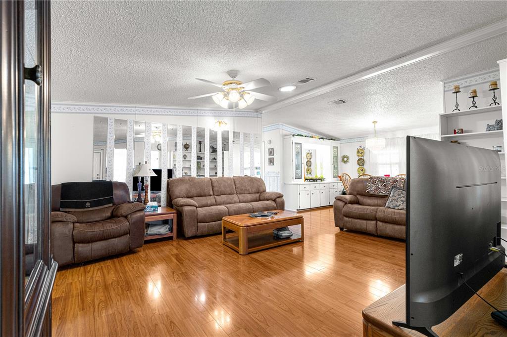 13081 Southeast 47th Court Belleview, FL 34420 - Photo 16 of 42 a living room with furniture and a flat screen tv