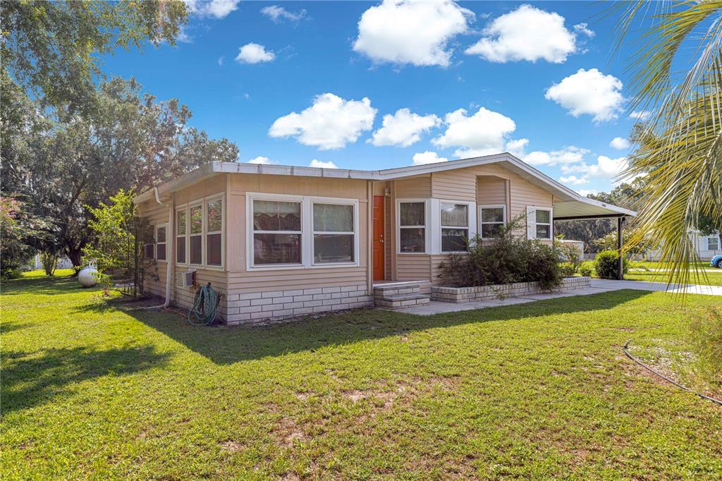 13081 Southeast 47th Court Belleview, FL 34420 - Photo 2 of 42 a view of a house with a yard and swimming pool