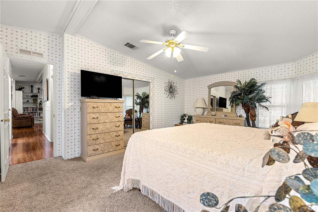 13081 Southeast 47th Court Belleview, FL 34420 - Photo 21 of 42 a bedroom with a bed and a flat screen tv