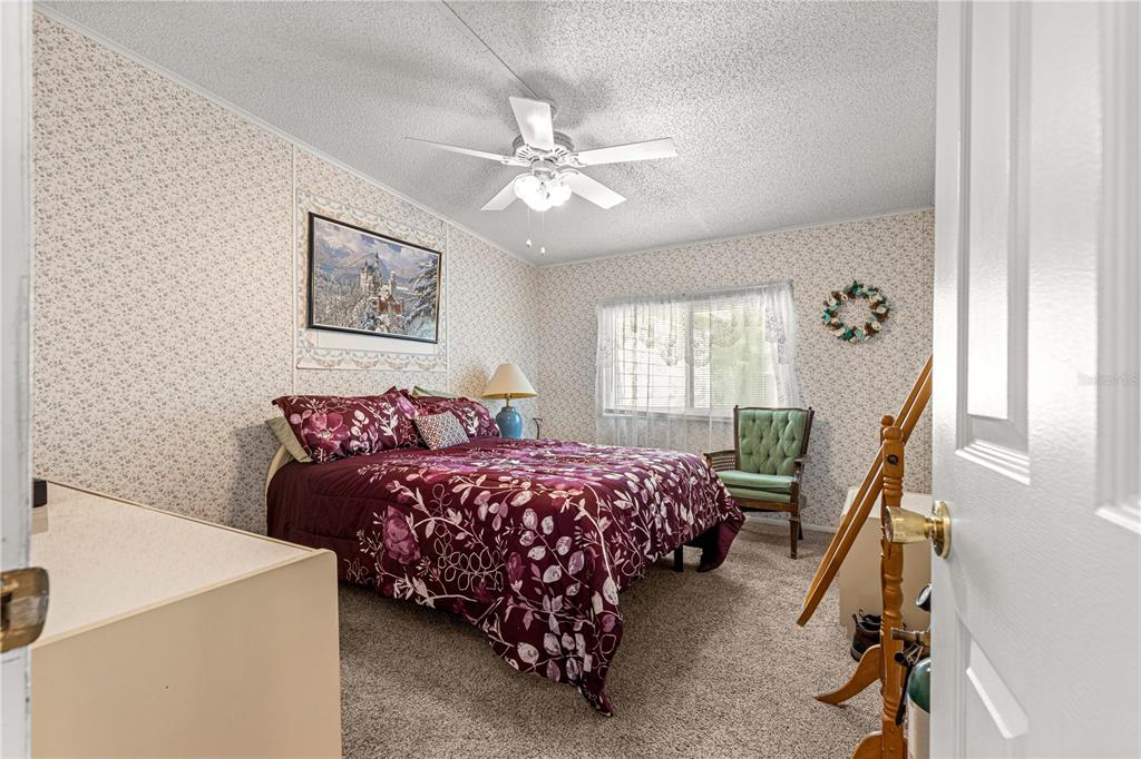 13081 Southeast 47th Court Belleview, FL 34420 - Photo 27 of 42 a bedroom with bed and window