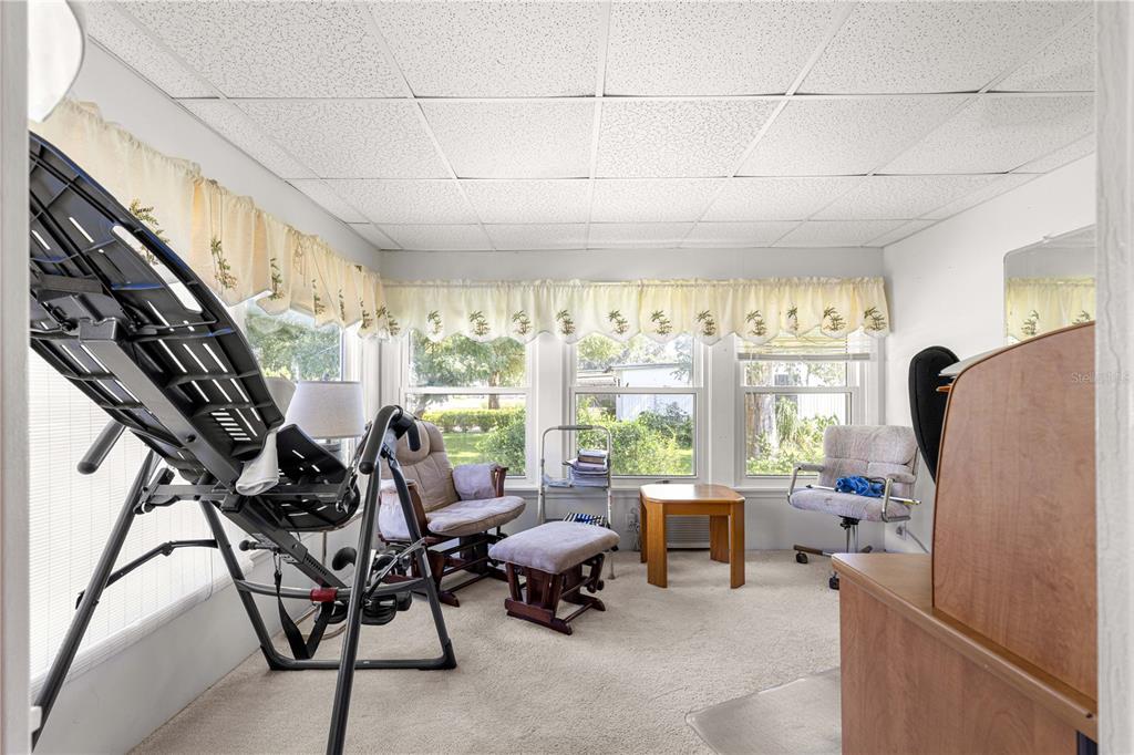13081 Southeast 47th Court Belleview, FL 34420 - Photo 32 of 42 a living room with furniture and a large window