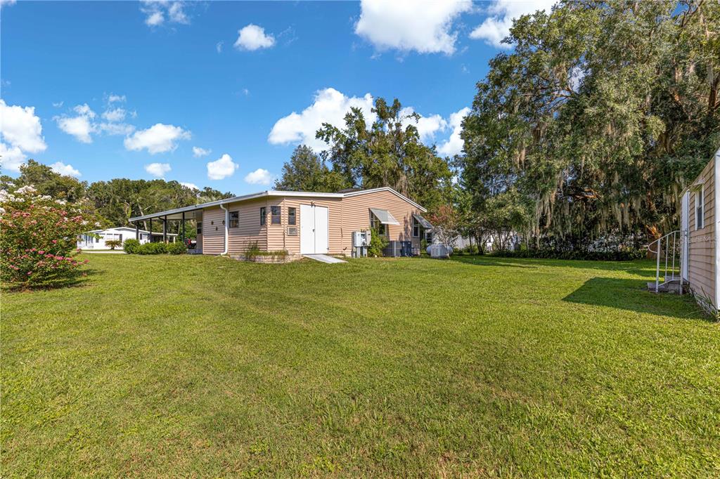13081 Southeast 47th Court Belleview, FL 34420 - Photo 35 of 42 a house view with swimming pool in front of it