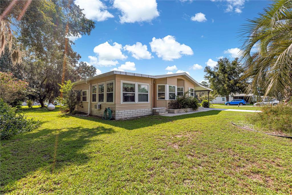 13081 Southeast 47th Court Belleview, FL 34420 - Photo 38 of 42 a view of a house with a swimming pool