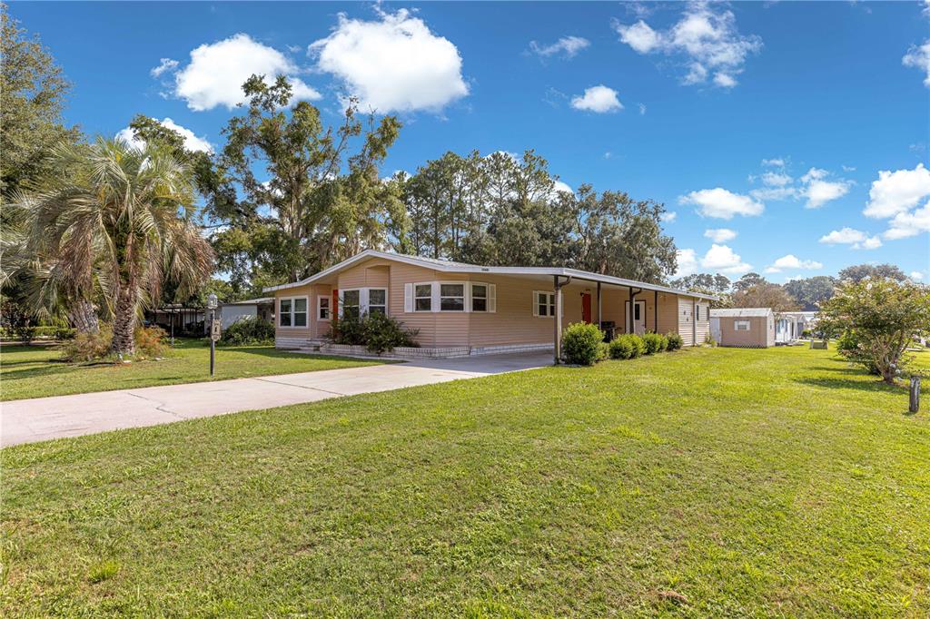 13081 Southeast 47th Court Belleview, FL 34420 - Photo 4 of 42 a front view of house with yard and green space