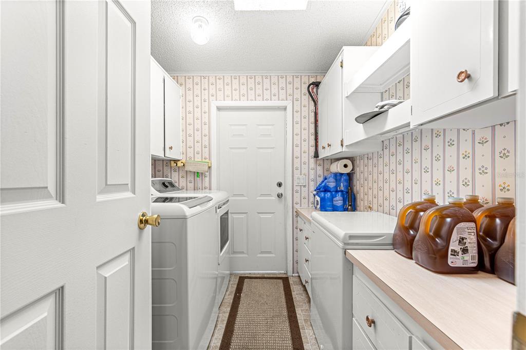 13081 Southeast 47th Court Belleview, FL 34420 - Photo 6 of 42 a utility room with dryer and washer