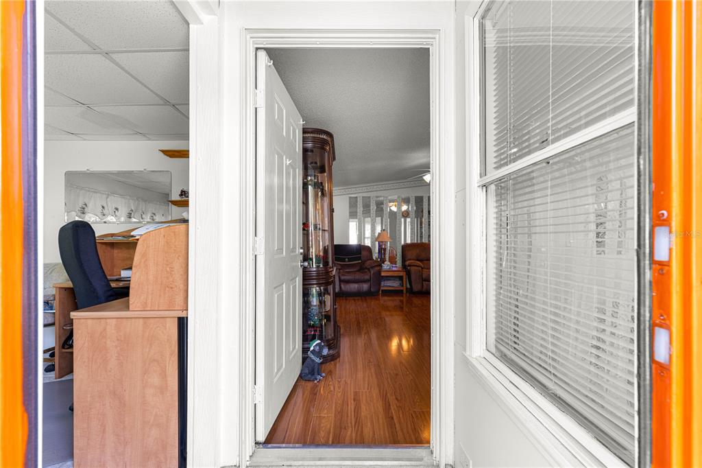 13081 Southeast 47th Court Belleview, FL 34420 - Photo 8 of 42 a view of a hallway and a livingroom with furniture