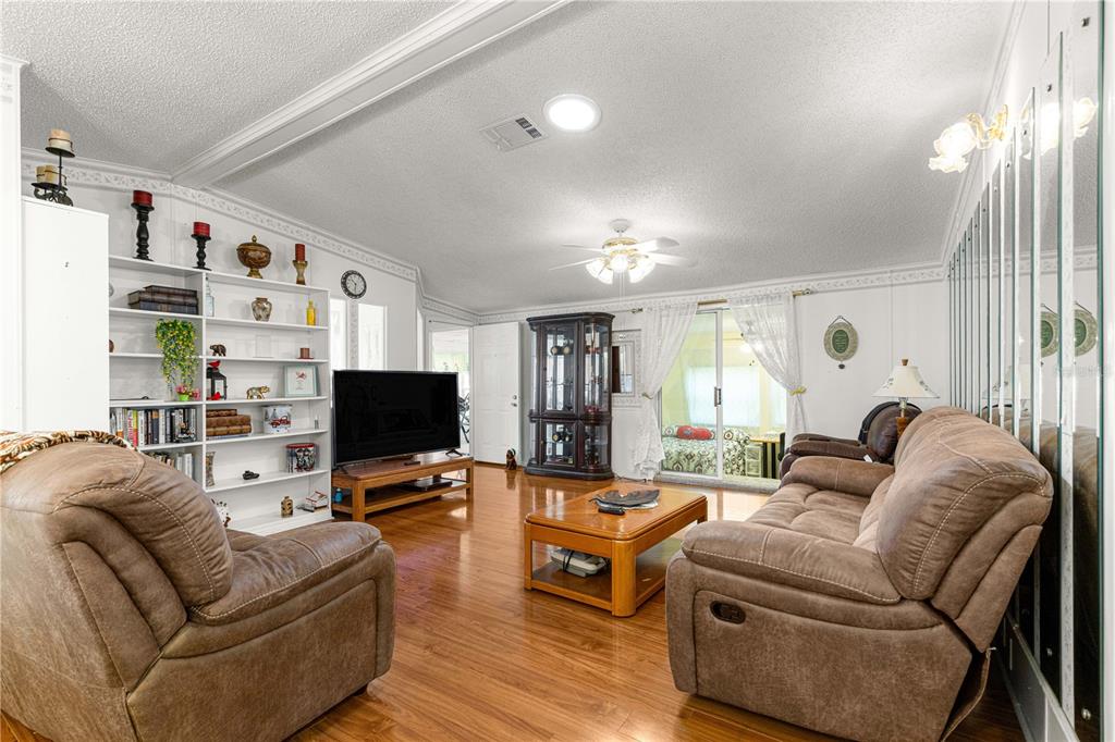 13081 Southeast 47th Court Belleview, FL 34420 - Photo 9 of 42 a living room with furniture and a flat screen tv