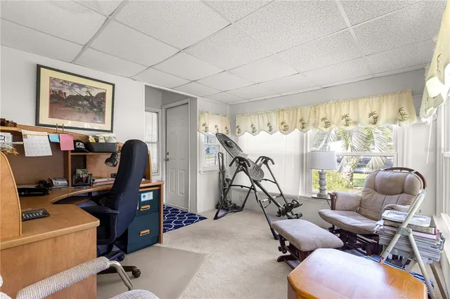 a view of a workspace with furniture and a window