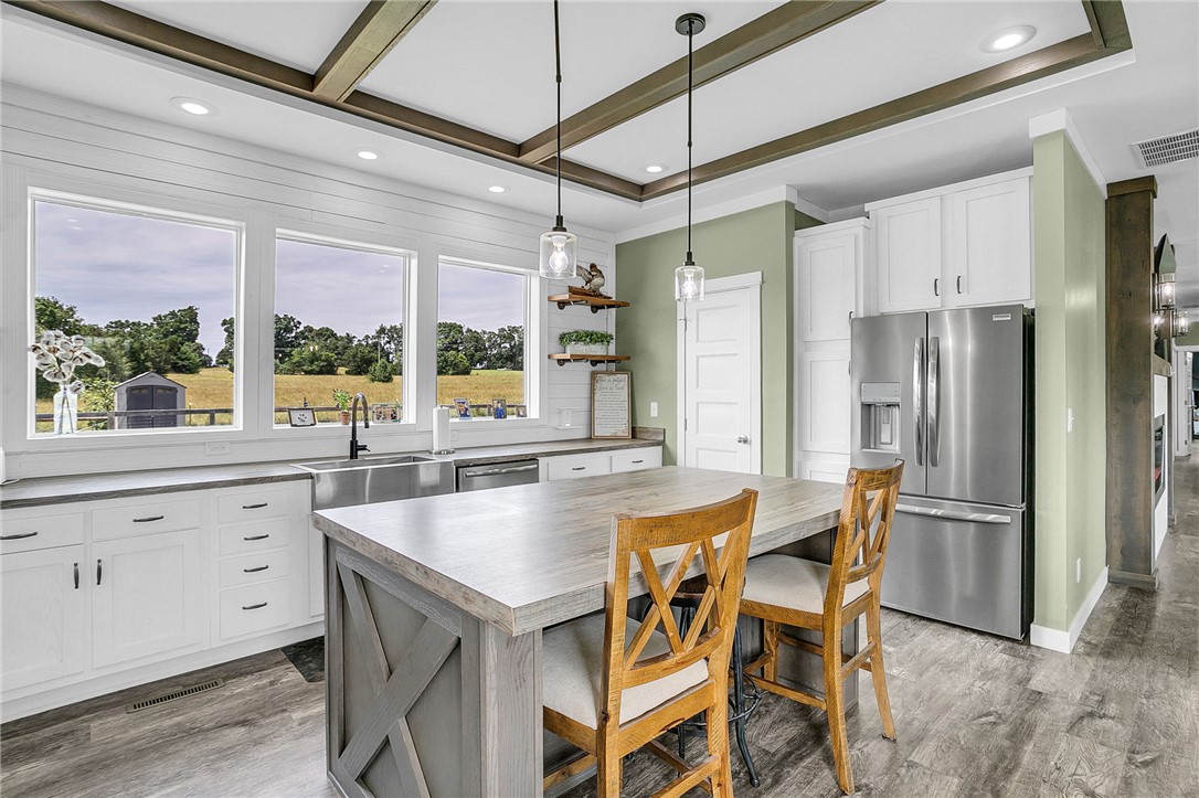 615 Wilson Road Central, SC 29630 - Photo 8 of 50 Exquisite wood ceilings and expansive windows look out over rolling fields in this kitchen.
