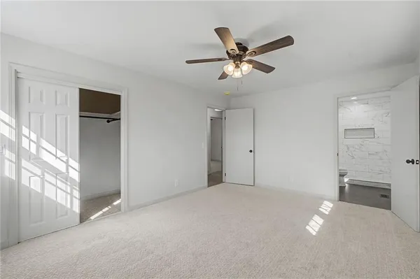 a view of a livingroom with a ceiling fan and window